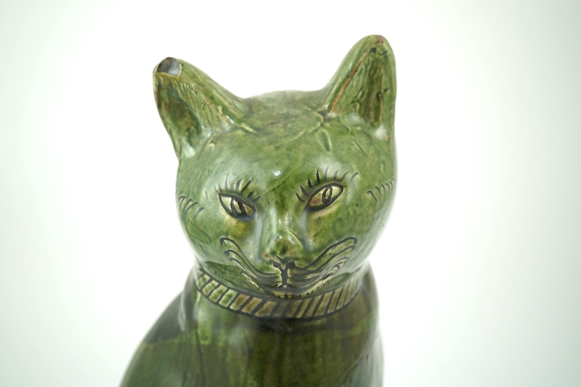 Ewenny Pottery: A large green-glazed figure of a seated cat